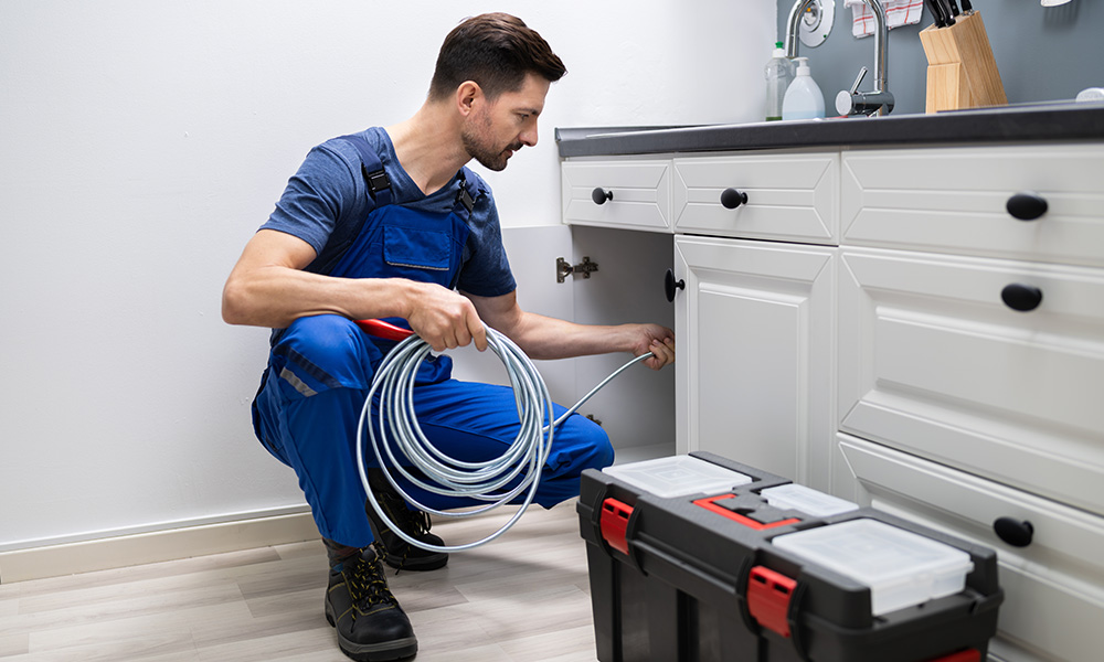 Plumber checking signs of a blocked drain