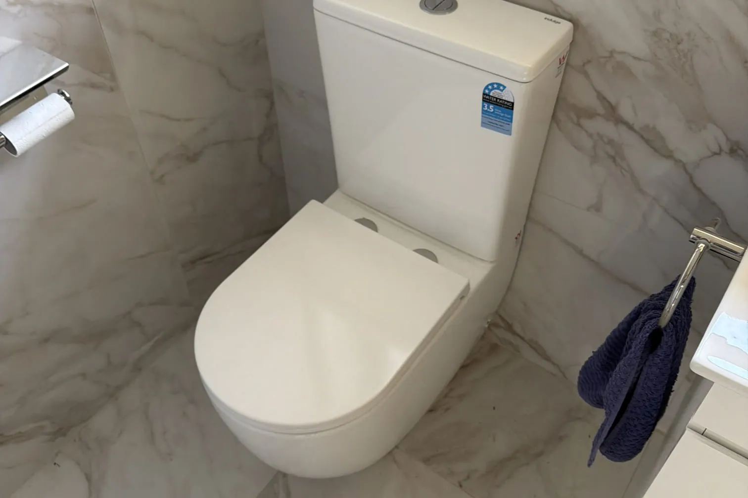 Back-to-wall toilet in a marble-look bathroom