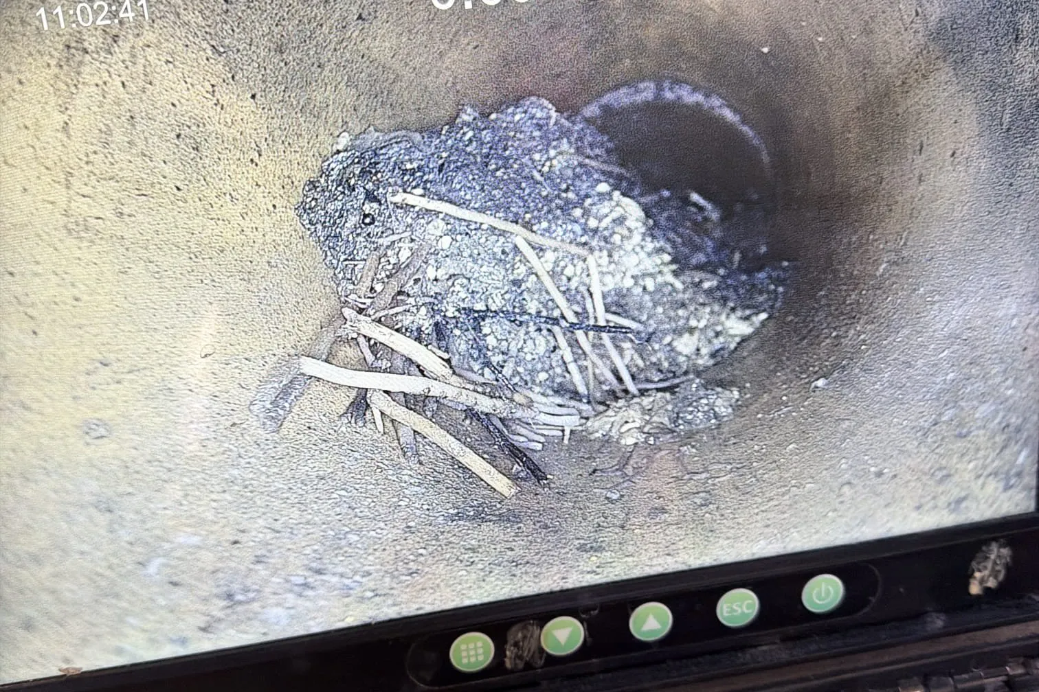 Drain camera footage showing debris blocking a pipe