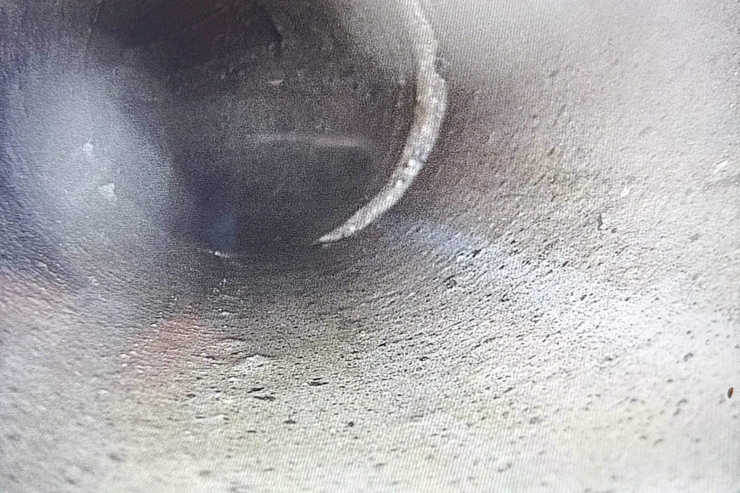 Drain camera screen showing the inside of a sewer pipe