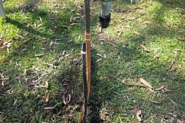Leaking pipe and tap fitting in a lawn