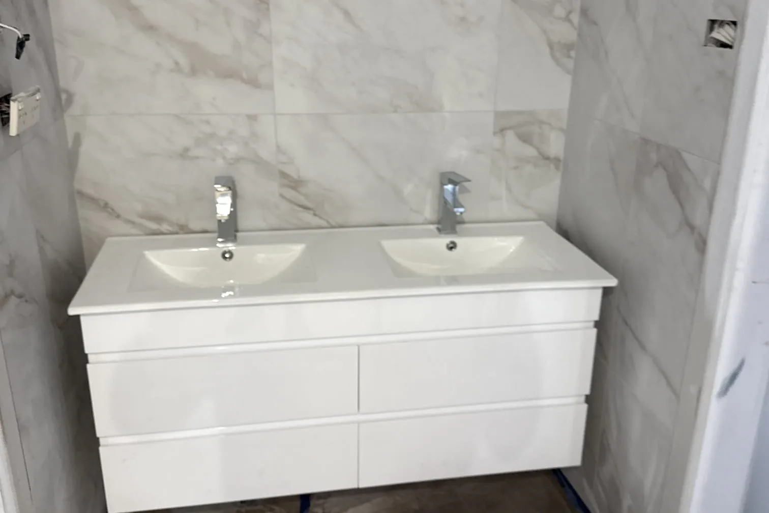New double vanity in a tiled bathroom