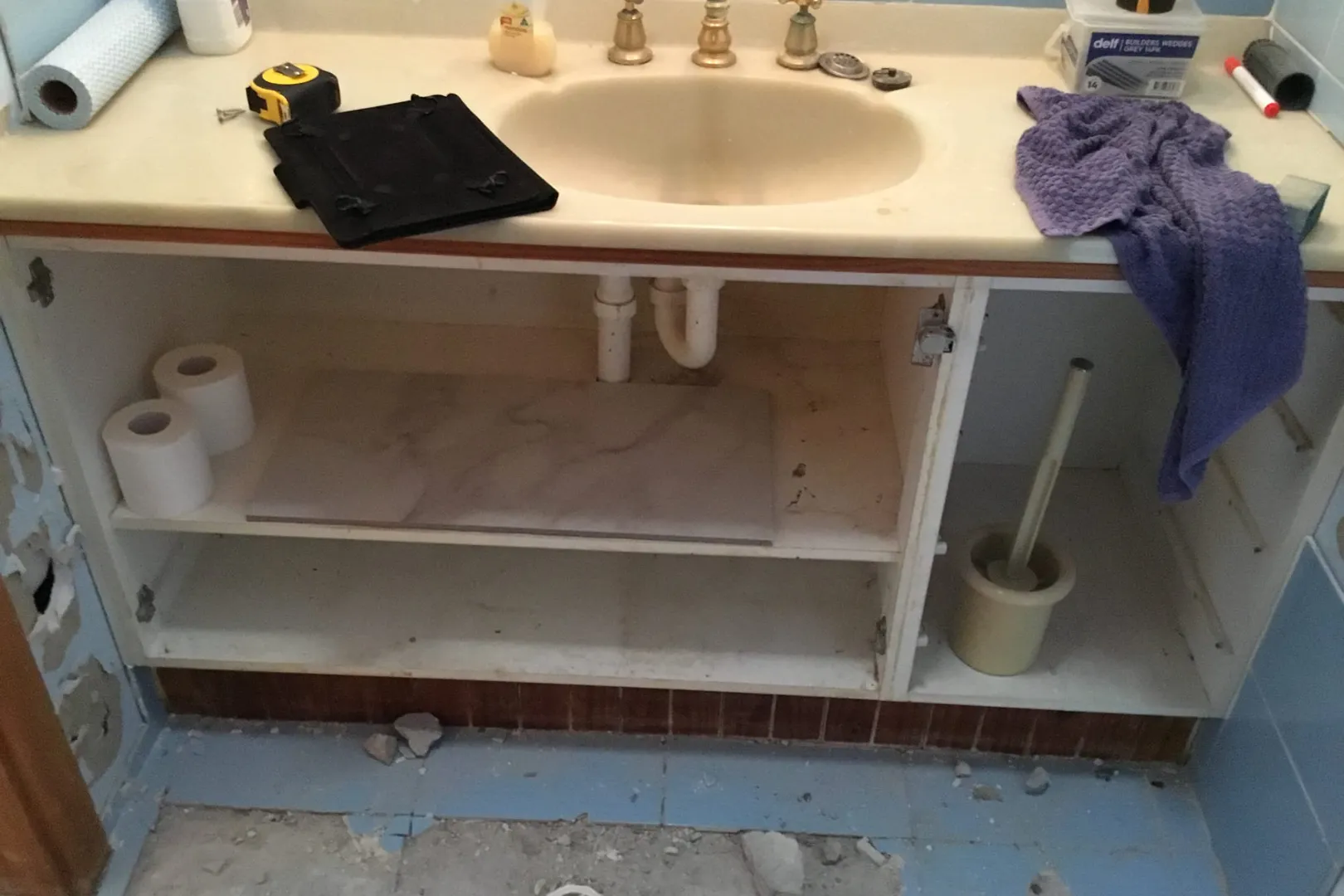 Old vanity with the plumbing exposed underneath